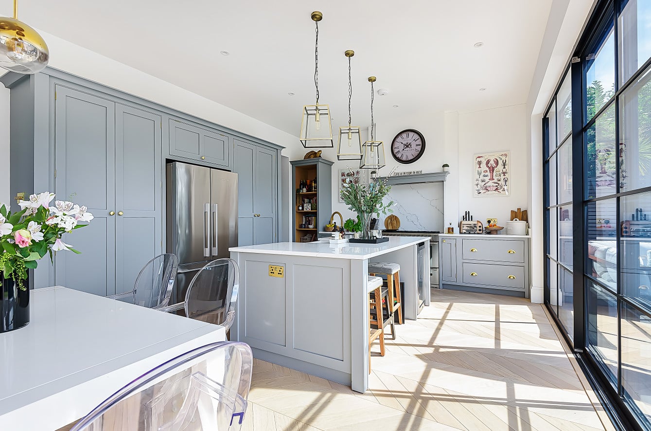 Close-up of precision joinery and hand-painted kitchen cabinet detail showing expert craftsmanship